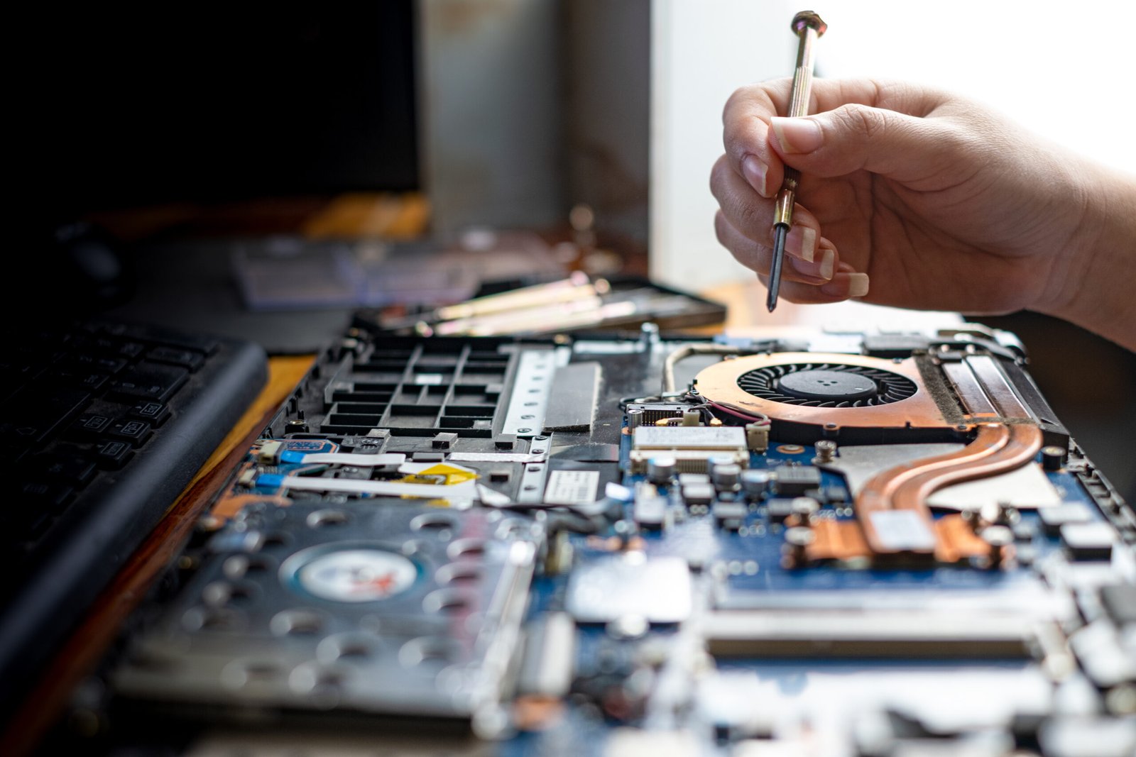 technician repairing broken laptop notebook computer